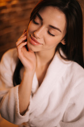 woman relaxing in robe at the spa