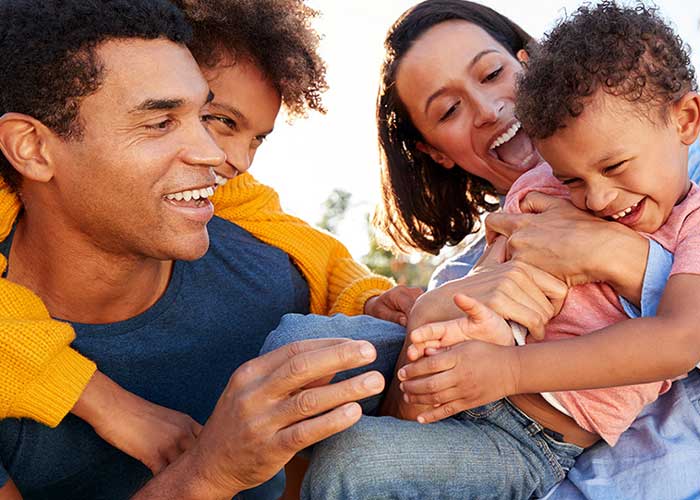 Family laughing and enjoying time together.